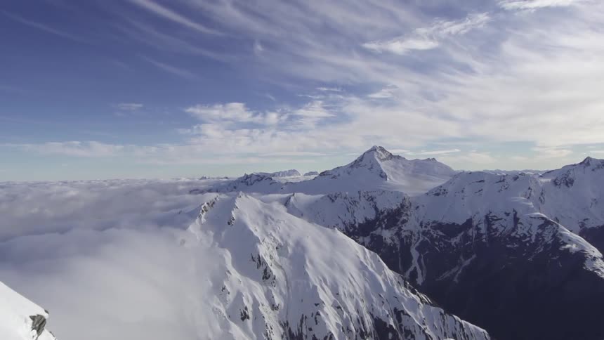Snow capped mountains and ridges in the clouds
