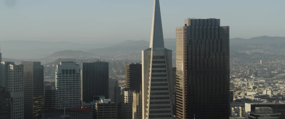 Sun shines down over skyscrapers in a large city