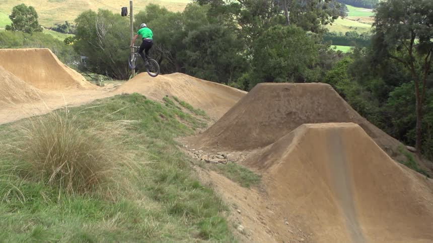 Man jumping on a dirt hill on his bike