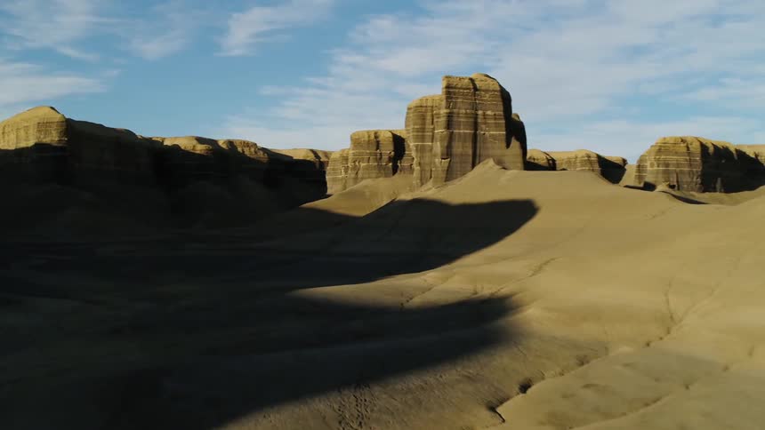 Sun casts shadows over rocky plateaus