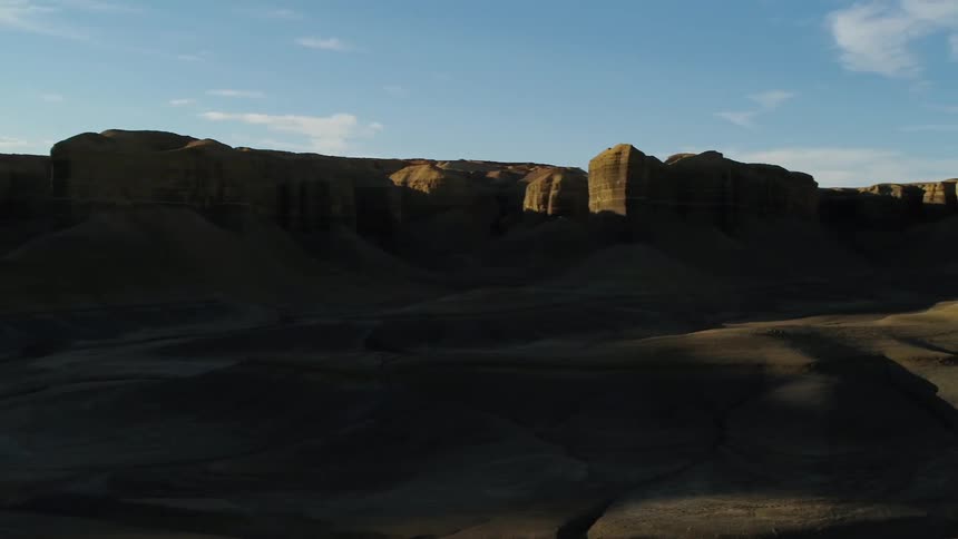 Sun setting behind hills in the desert