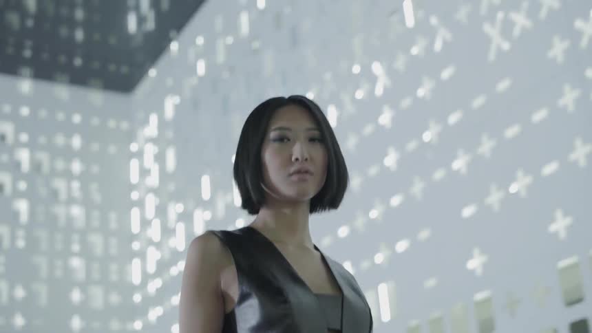 A woman walks down the hall with flashing lights