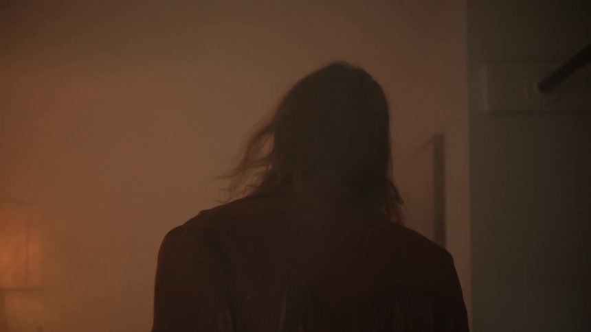 Man opens a door and walks into a smoky room