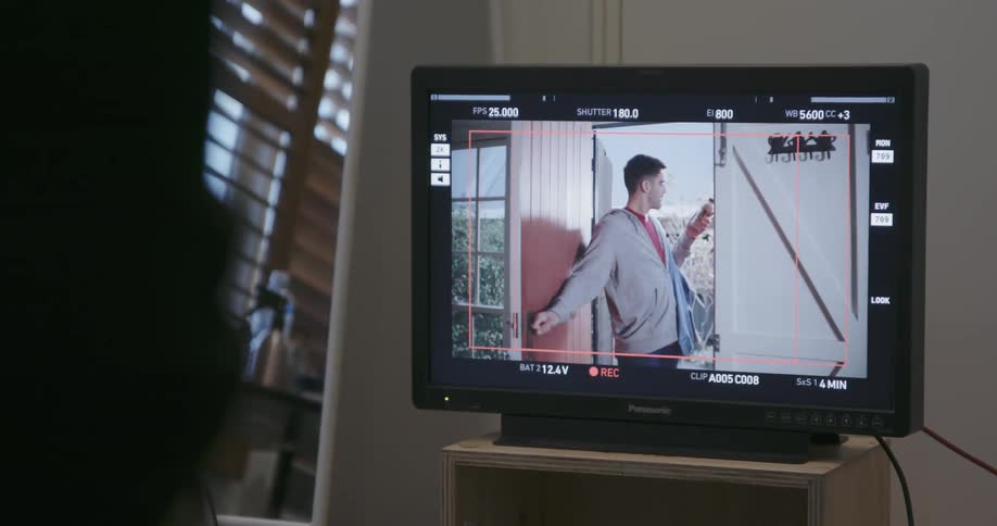 A filmed scene is played on a monitor