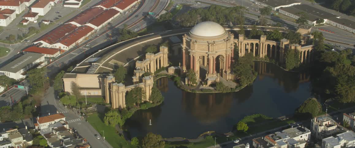 Large building next to roads and a body of water