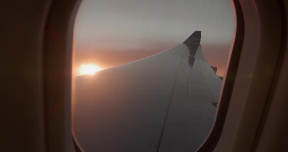 Sun shines over an airplane wing