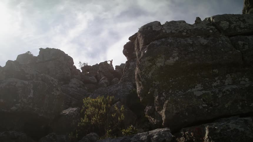 Man jumps on rocky cliffs