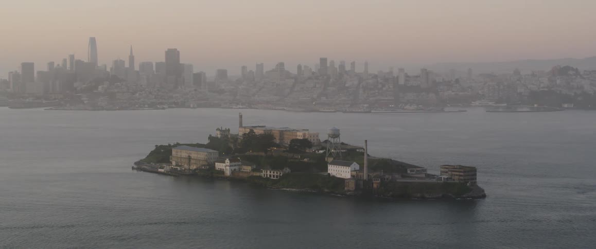 Island with buildings on it in the middle of a large body of water