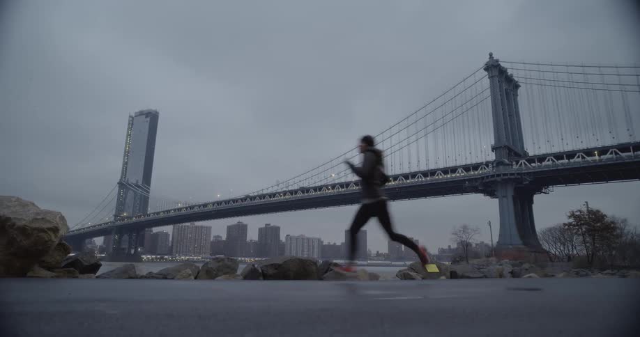 A woman jogs past the bridge
