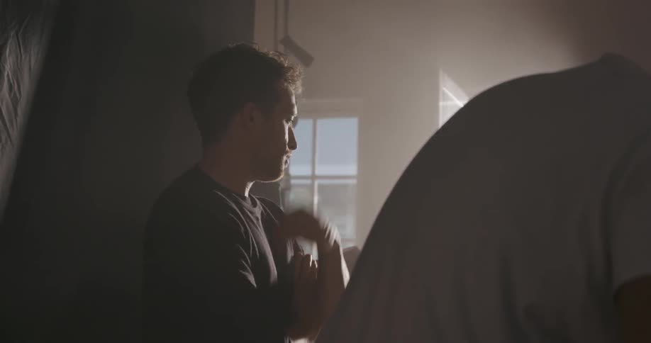 Men on a set talk and nod