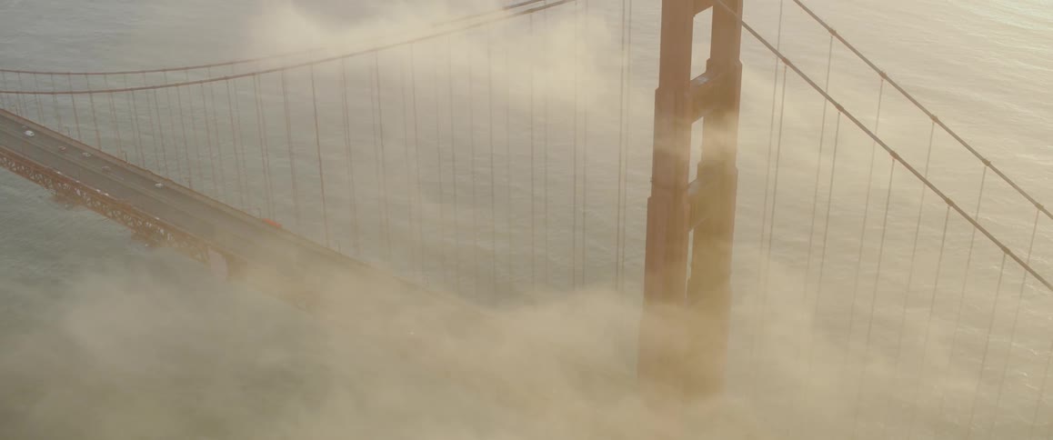 The fog is flowing over the large bridge