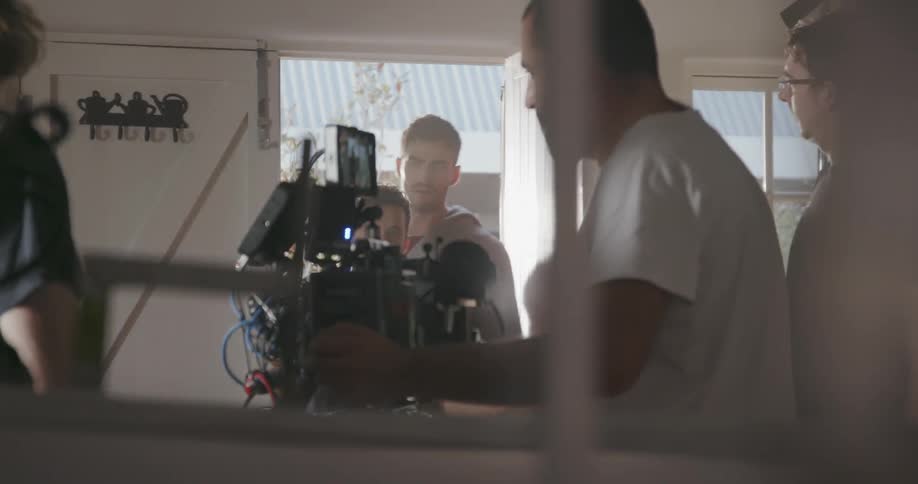 A man adjusts an expensive looking camera