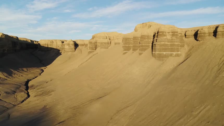 Sandy desert with hills and tall plateaus