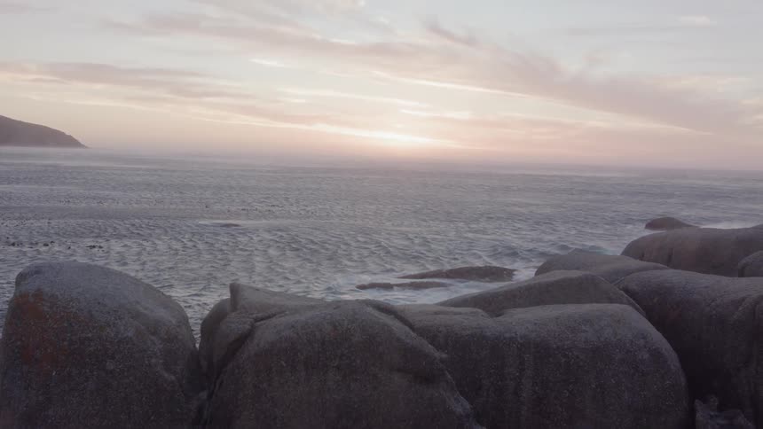 Sun rises over a flowing body of water