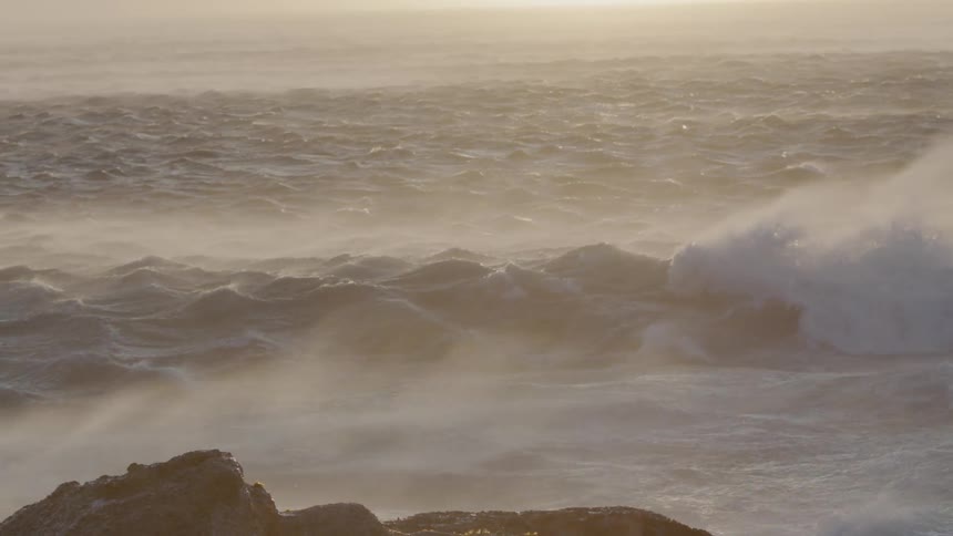Water ripples and mists near the beach at sunset
