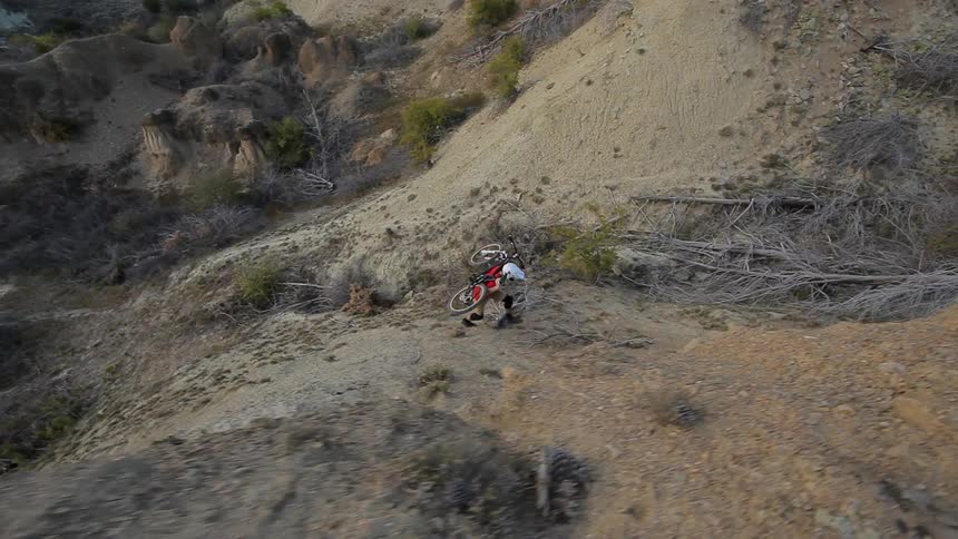 A man carrying a bicycle up a hill