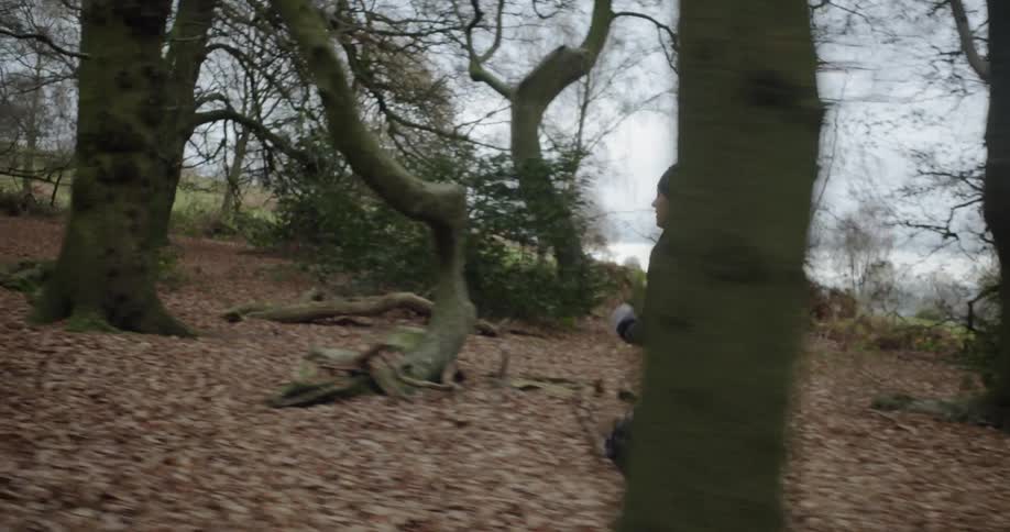Woman jogs through the woods