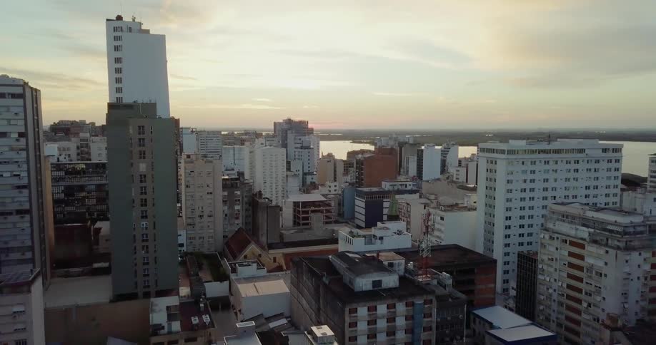 Rooftops and buildings of a city at sunset