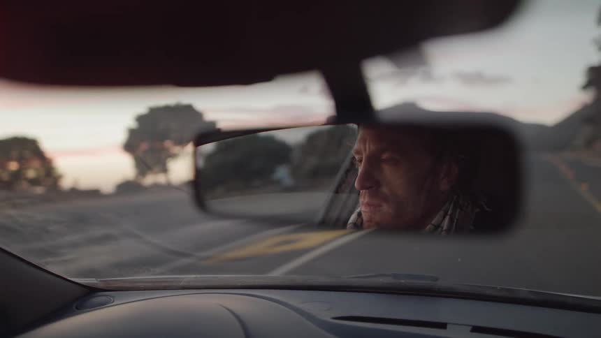 A man drives a car on the road