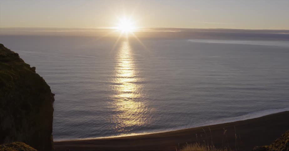 Sun sets over a large flowing lake