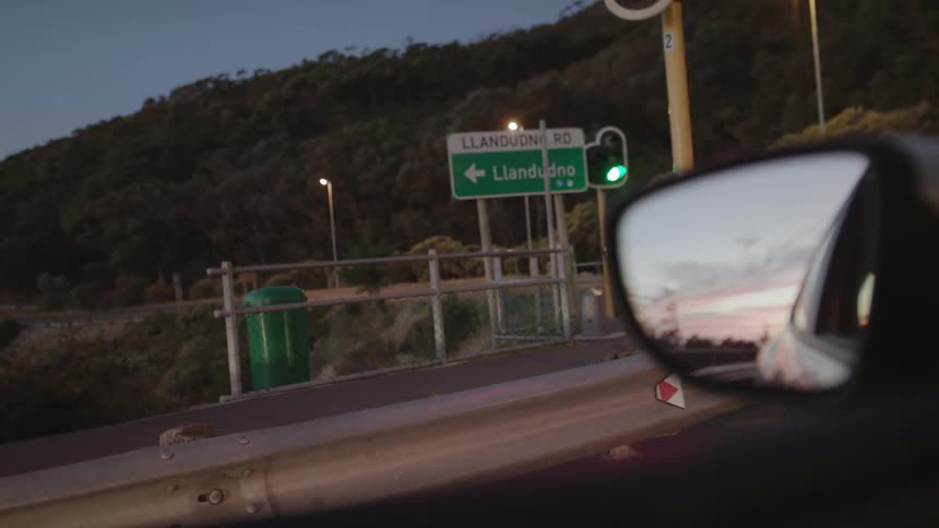 Stoplight shows a green light as a car sits nearby