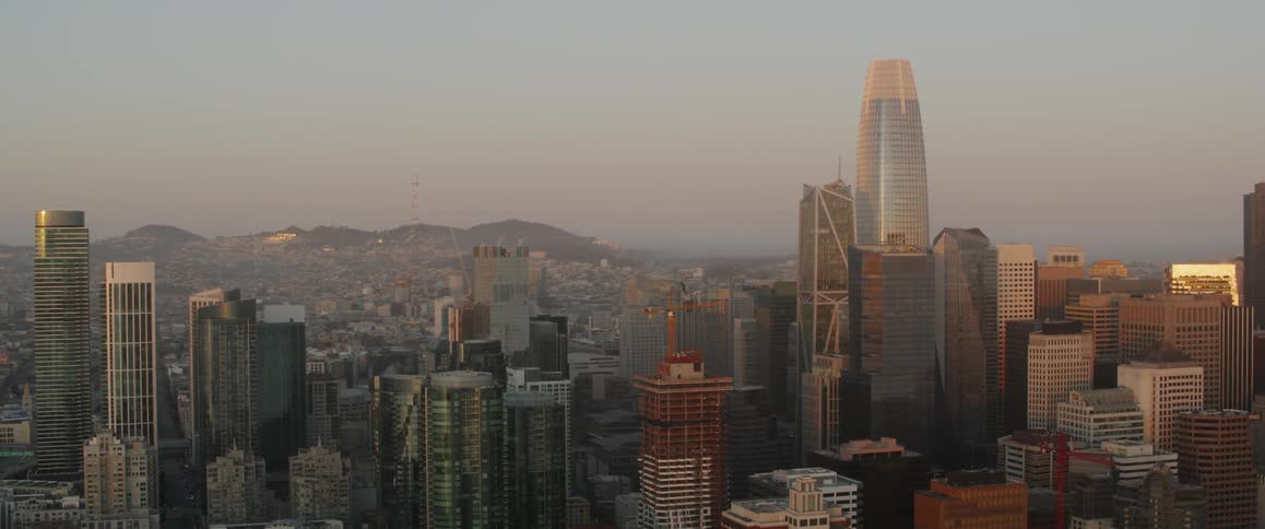 Large city near hills at sunset