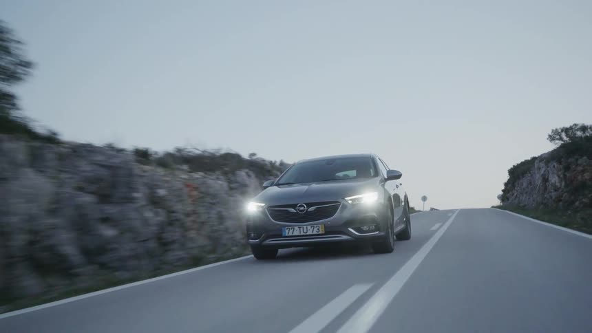 The silver car drives around the road