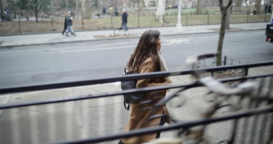 Woman runs down the city sidewalk