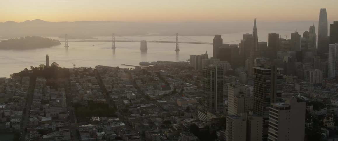 The bridge reaches the city at sunset