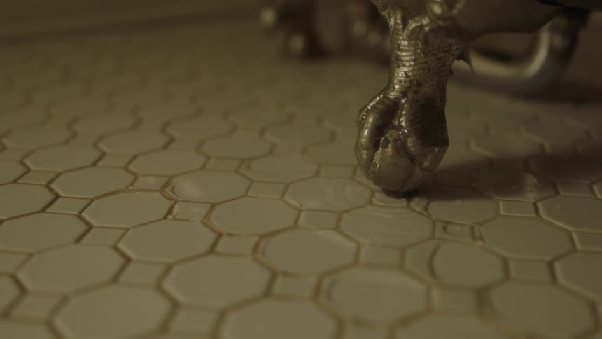 Water is flooding off a metal object onto a countertop in daylight