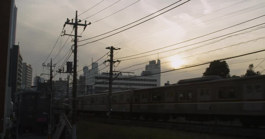 Train passes through Tokyo on a sunny day
