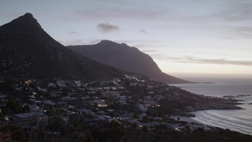The town sits by the mountain near the shore