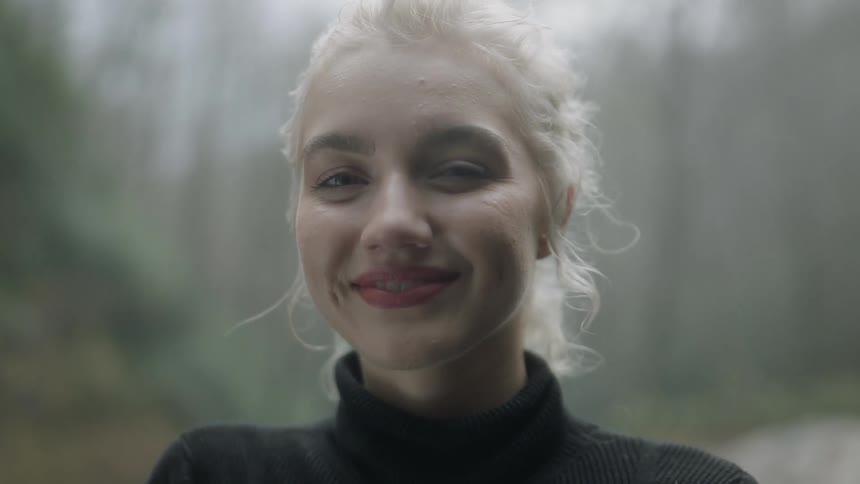 A blond haired woman smiles