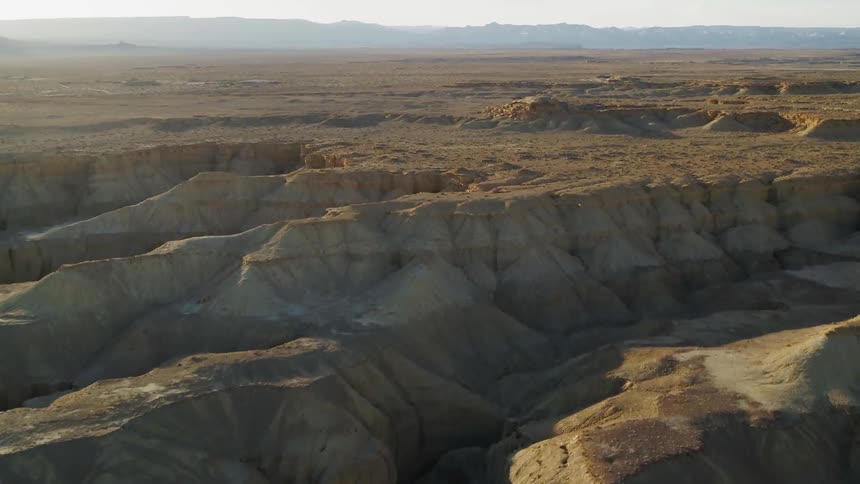 Sun shines over rocky hilly landscape