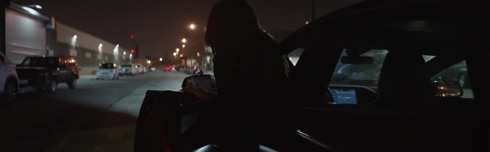 A woman exits a car