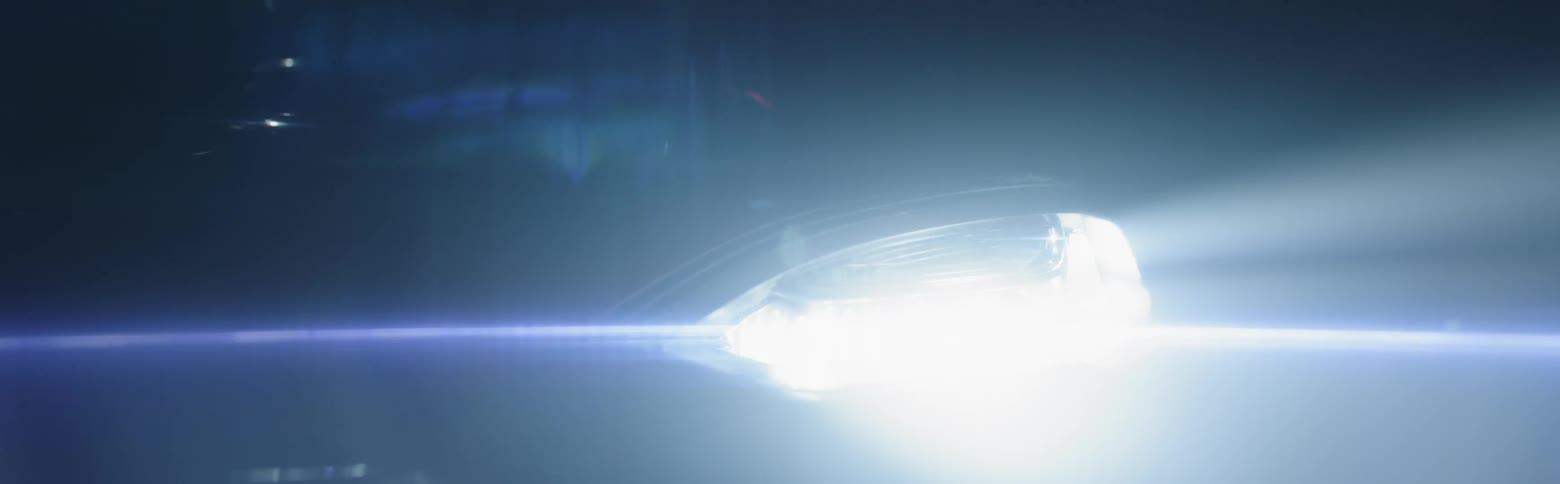 A car's headlight turns on
