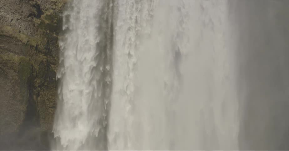 The huge waterfall is dropping water in all directions