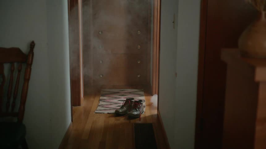 Smoke blows into the hallway from an adjacent room