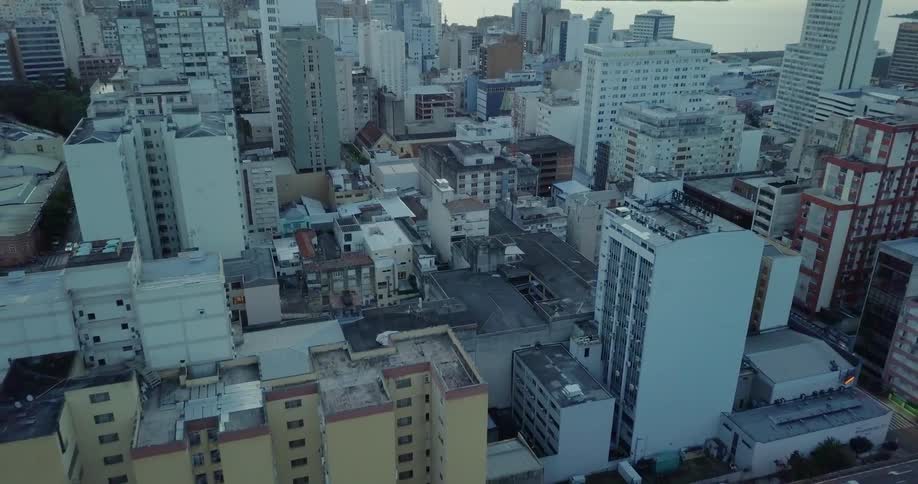Many buildings in a large city next to a river