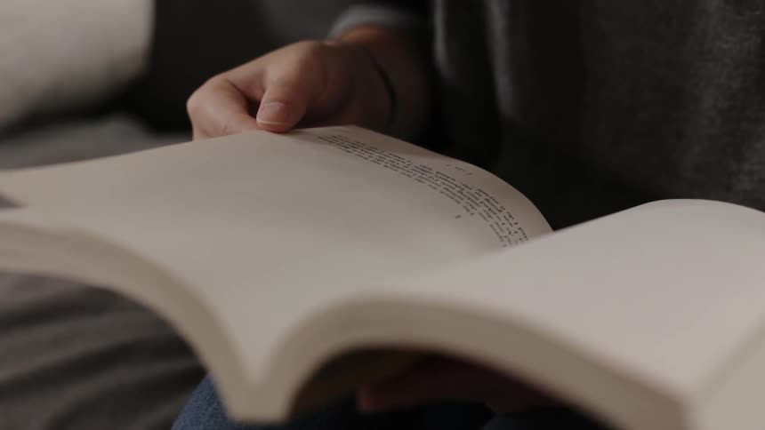 Woman flipping through pages in book