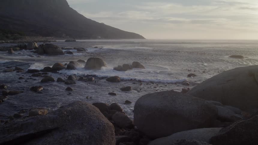 Water mists and splashes on rocks on the beach
