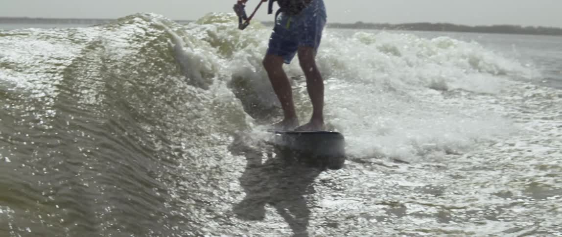Man surfs over the crashing waves