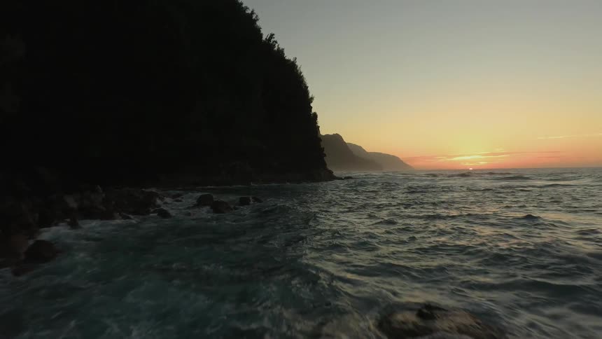 The tide flows onto the rocky shore