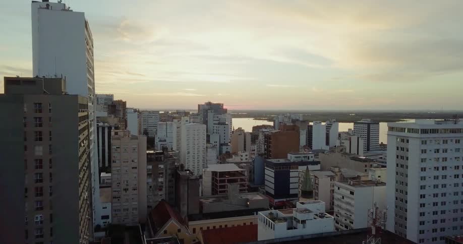 The tall buildings lead to the water ahead