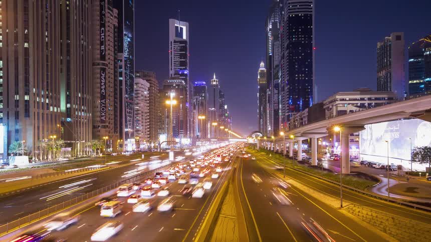 Lanes of traffic travels down the city streets at night