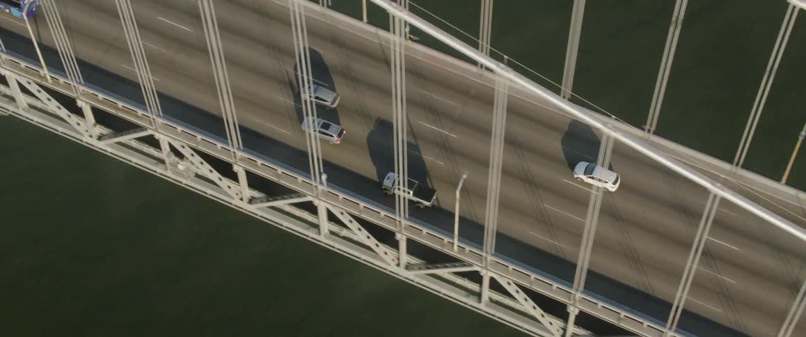 Vehicles driving on a bridge over a large body of water