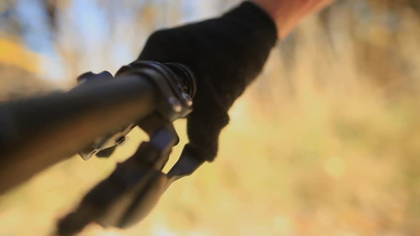 A person shifting gears on their bike