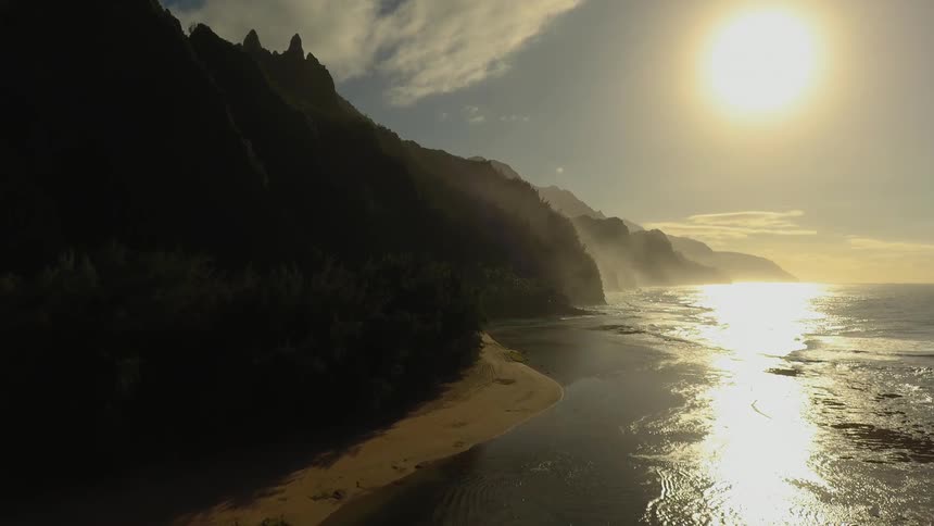 Sunshine over mountains next to the beach