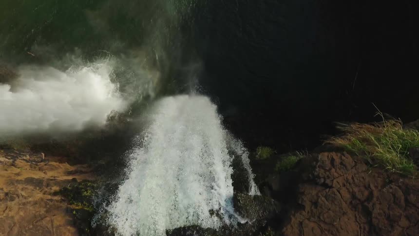 Stream of water splashes down into a pool below