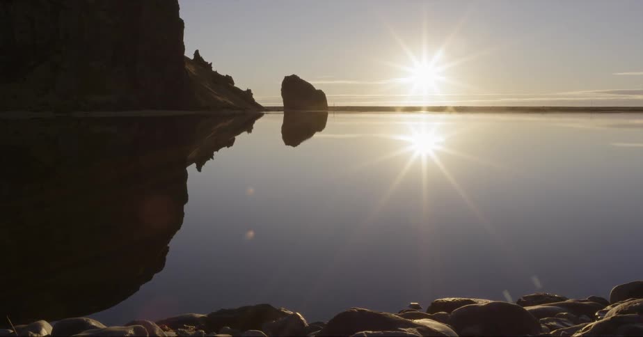 The sun shines on and reflects off of the clear water